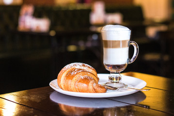 Coffee latte big cup, croissants on dark retro background, selective focus. Breakfast concept