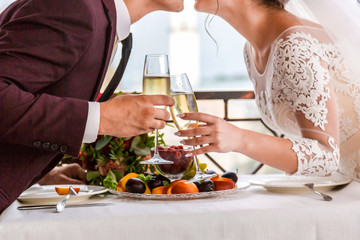 Celebration of the wedding day with glasses of champagne. The bride is toasting with champagne