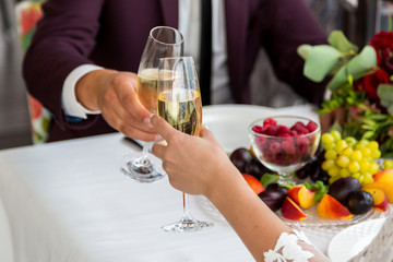Celebration of the wedding day with glasses of champagne. The bride is toasting with champagne