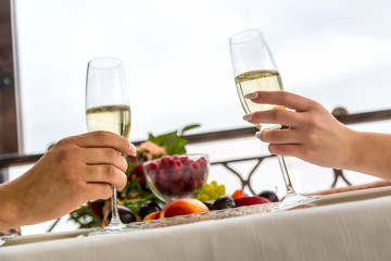 Celebration of the wedding day with glasses of champagne. The bride is toasting with champagne