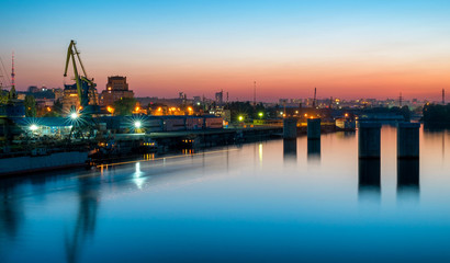 Fototapeta premium Industrial river port with reflection in the water