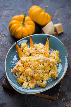 Pumpkin risotto with parmesan cheese, selective focus, vertical shot