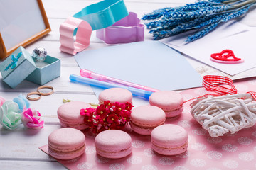 Pink heart shaped macaroons and wedding rings with postcard, Photo frame
