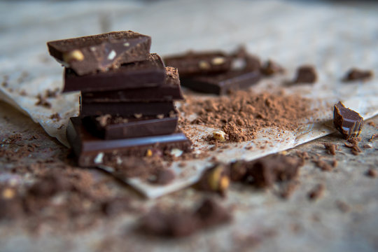 Dark chocolate stack with hazelnuts, selective focus
