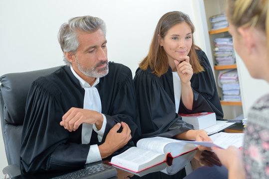 Woman in meeting with two legal professionals