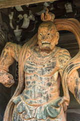 Obraz premium Giant statue guarding the gate at Daisho-in Temple, Miyajima, Japan.