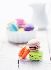 Vibrant colorfull macarons on white wooden table. Text space