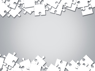 White jigsaw puzzle on gray background with copy space