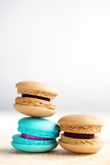 stack of Vibrant colorfull macarons on white wooden table. Text space