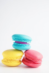 stack of Vibrant colorfull macarons on white wooden table. Text space