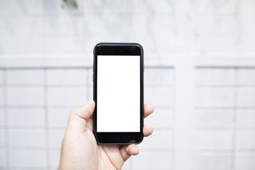 Man holding phone on street show screen for insert logo or advertising in isolated