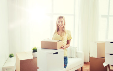 smiling young woman with cardboard box at home