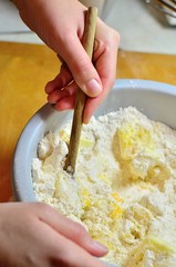 Kneading dough with hands on apple pie