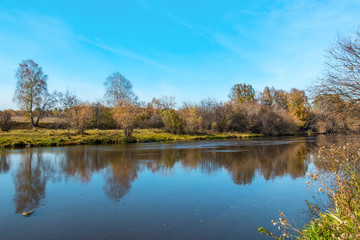 bright autumn landscape on the river bank