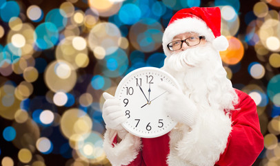 santa claus with twelve on clock at christmas