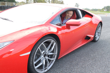 Fototapeta na wymiar Portrait of man in red sports car