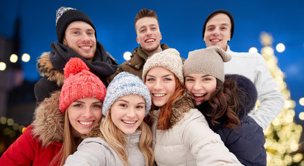 happy friends taking selfie outdoors at christmas