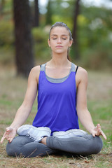 Fototapeta premium woman on a yoga mat to relax outdoor