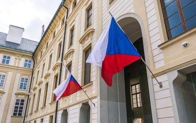 National flags of the Czech Republic on the facade of the government building in Prague