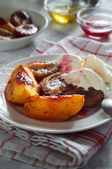 Baked plums and peaches with ice cream honey and cinnamon