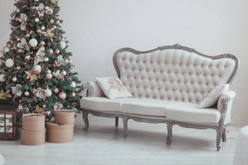 Christmas and New Year Eve Tree. Holiday winter background. Interior details - sofa, vintage gifts, candles. Isolated wall
