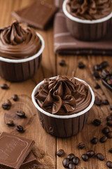 Homemade chocolate cupcakes on wooden background