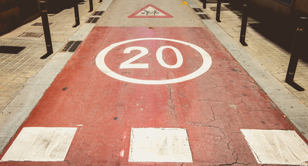 in front of a pedestrian crossing, white paint forbidden to exceed the speed of 20
