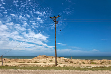Electric pole by the sea