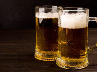 Two glass beer on wood background with copyspace