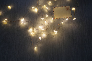 the Garland with White Christmas Tree Lights with Rustic Wood Background