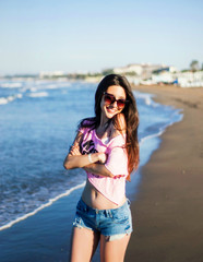 Happy girl smiling and posing near the sea