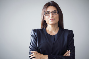 Portrait of businesswoman on grey background