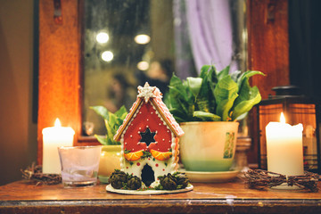 Gingerbread house making by hands. Christmas holiday.