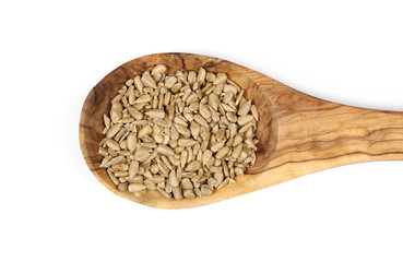 Sunflower seeds in wooden spoon isolated on white background, top view