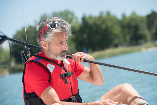 man sailing on river at sunny summer day