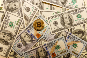 Golden bitcoin on us dollar bills electronic money exchange concept