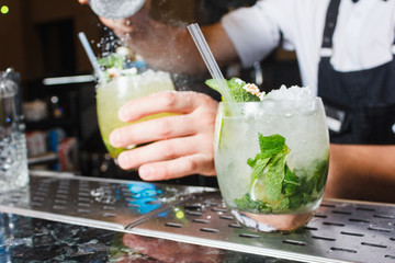two mojito cocktail hand barman