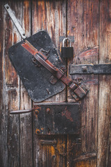 Nice photo about Old door, blacksmith metal latch lock