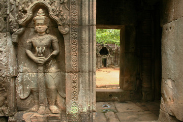Entrance to inner sanctuary of Ta Som temple in ancient Angkor in Cambodia guarded by armed dvarapala, a temple guard.