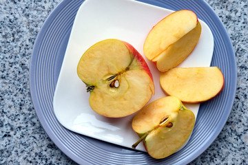 Apple pie with walnuts on gray plate