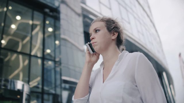 Young Businesswoman Walking and Talking on the Phone