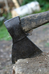 The axe sticks in the log
