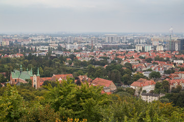 Fototapeta na wymiar Oliwa district and beyond in Gdansk, Poland, viewed from above on a cloudy day.