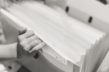 Close up on schoolchild holding plastic folder, abstract educational background. Top side view image
