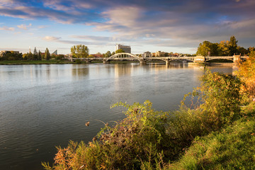 Fototapeta premium Bridge in Piestany (Slovakia), dark sky + colorful autumn