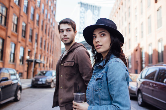 Young couple walking in Dumbo Area, Brooklyn, New York.