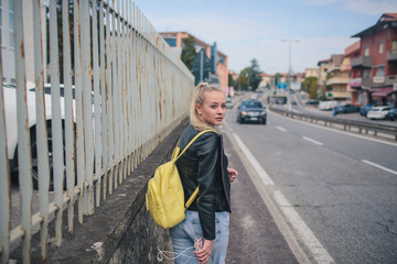 Obraz na płótnie Canvas girl in a black leather jacket on the road