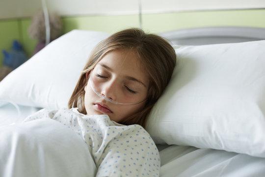 Close up of patient child sleeping in a hospital bed