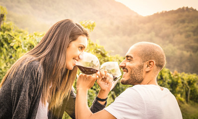 Happy young couple of lover drinking red wine at vineyard farmhouse - Handsome man looking at...