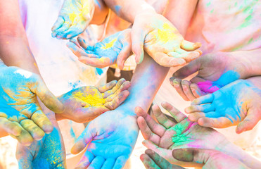 Obraz na płótnie Canvas Bunch of colorful hands of friends group having fun at beach party on holi color festival summer vacation - Young people enjoying time together - Youth friendship concept with multicolored powder game
